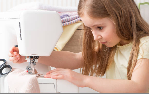 istock girl working with sewing machine 1282682148