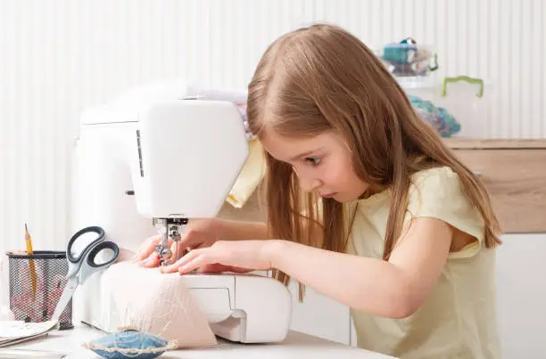 Photo of girl working with sewing machine
