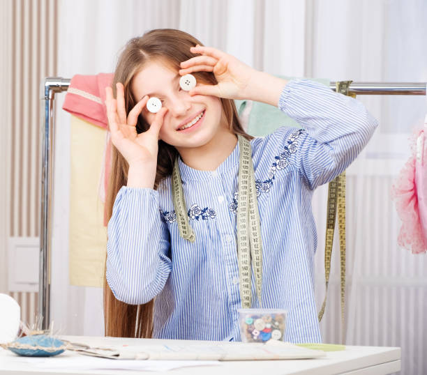 istock Seamstress girl with plastic buttons 1282682215