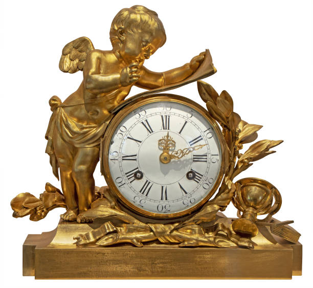 Old vintage gilded table clock with an angel, isolated on a white background