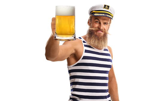 Bearded guy sailor toasting with a mug of beer isolated on white background