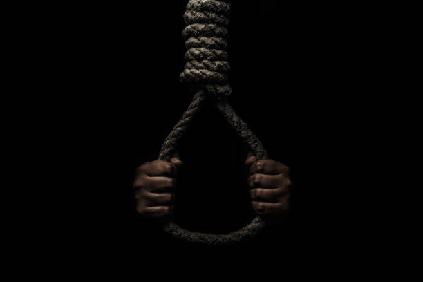 istock Hand holds a noose on a black background. Social problem. The end of the path 1282683823