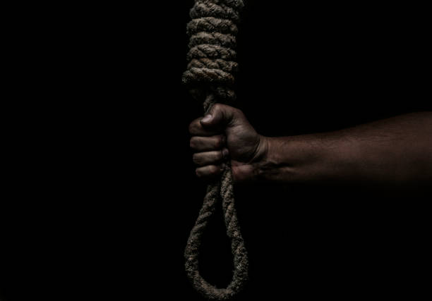 istock Hand holds a noose on a black background. Social problem. The end of the path 1282683829