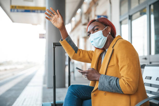 istock Woman travelling by train respecting rules and wearing a surgical face mask 1282684915