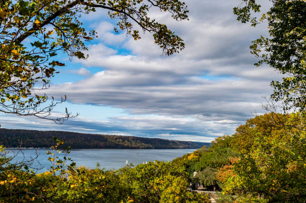Looking North through leaves up the Hudson River. The Palisades are in the background.