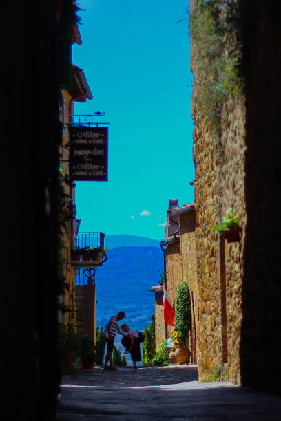 Alley of a characteristic village in the middle of ancient walls. Pienza is located in Val d'Orcia, a town in Tuscany and was declared a World Heritage Site by UNESCO\nVicolo di un caratteristico borgo al centro di antiche mura. Pienza si trova in Val d'Orcia, un comune della Toscana ed è stata dichiarata Patrimonio dell'Umanità dall'UNESCO