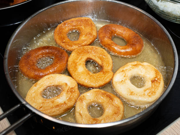 Home made Doughnuts being fried in a pan