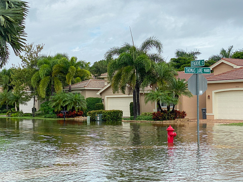 Boynton Beach, United States-October 23, 2020: Streets in a suburban residential community flooded due to a week long rainstorm that dropped over 20 inches of rain on South Florida. Extreme weather has become more common due to climate change and global warming.