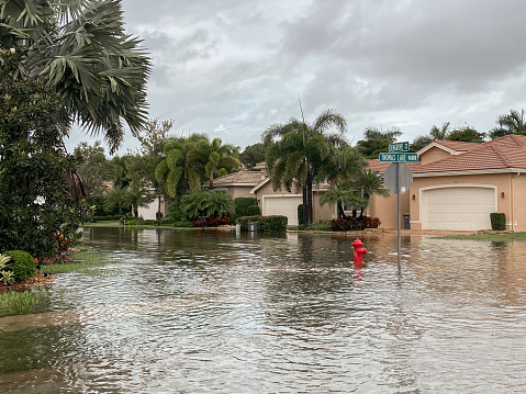 Boynton Beach, United States-October 23, 2020: Streets in a suburban residential community flooded due to a week long rainstorm that dropped over 20 inches of rain on South Florida. Extreme weather has become more common due to climate change and global warming.