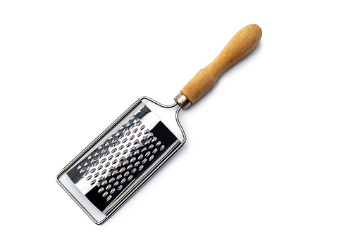 An close up view of a stainless steel grater with wooden handle