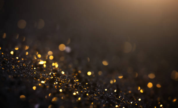 Black And Gold Glitter Background - Christmas, Celebration, Luxury Beautiful macro shot with copy space, perfectly usable for a wide range of topics. gold medal stock pictures, royalty-free photos & images