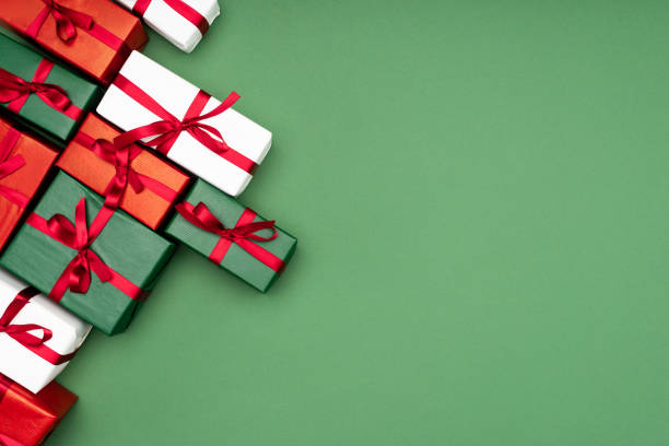 istock top view of multicolored gift boxes with red ribbons on green background with copy space 1282694411