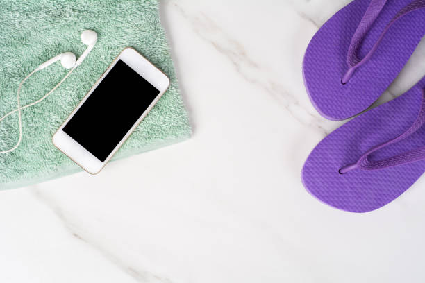 istock Smartphone, flip-flops and towel. 1282696897