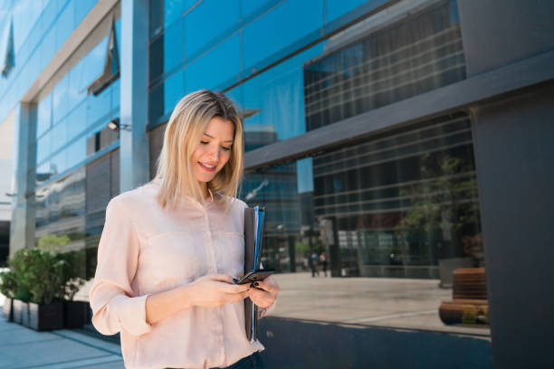 istock Business woman using her mobile phone outdoors. 1282696933