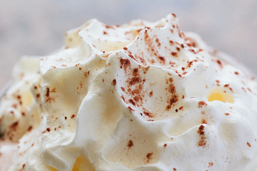 Macro shot of whipped cream with cocoa powder