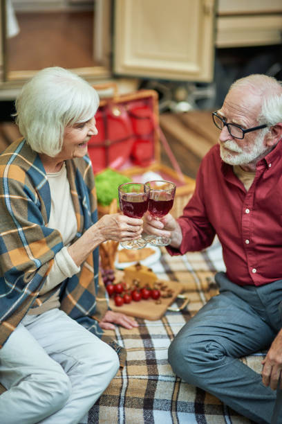 istock Smiling elderly couple enjoying the trip and celebrating with wine 1282700596