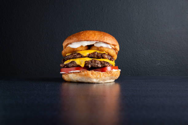 istock DOUBLE MEDALLON BURGER WITH CHEESE VEGETABLES AND DRESSINGS 1282700602