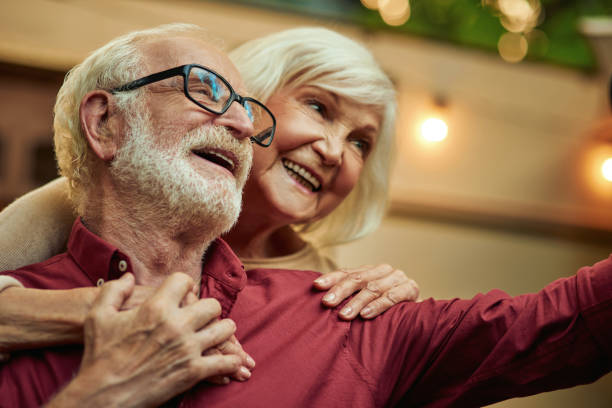 istock Happy man and woman hugging while posing for photo 1282700664