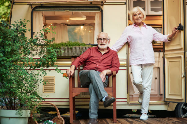 istock Happy elderly married couple near their camper van 1282700827