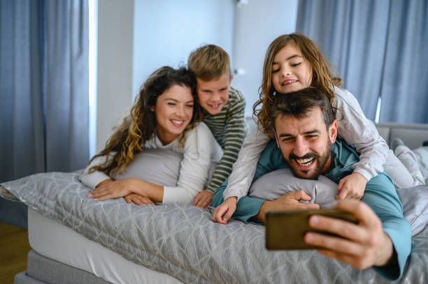 istock Family on bed taking selfie 1282700884