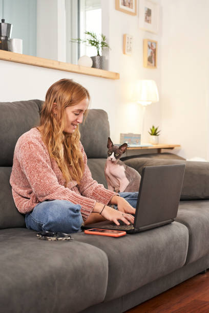 istock Woman writing on the laptop with her cat. 1282702229