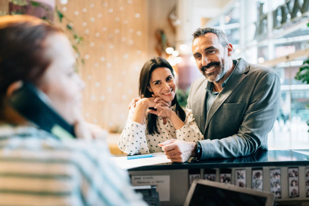 istock Couple Checking in at Hotel Reception 1282703362