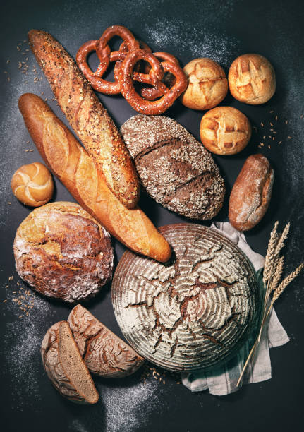 istock Delicious freshly baked bread assortment on dark rustic background 1282703846