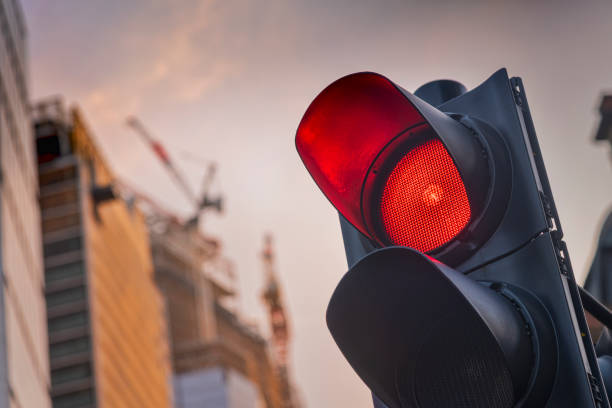 Red traffic light Red traffic light with a construction site in the background red light stock pictures, royalty-free photos & images