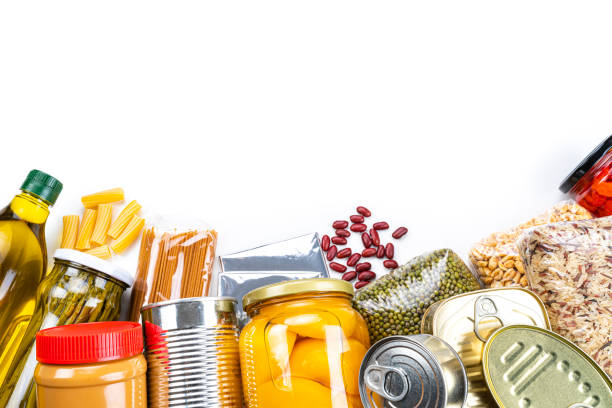 istock Non-perishable food frame: canned goods, conserves, sauces and oils with copy space. Overhead view. 1282707012