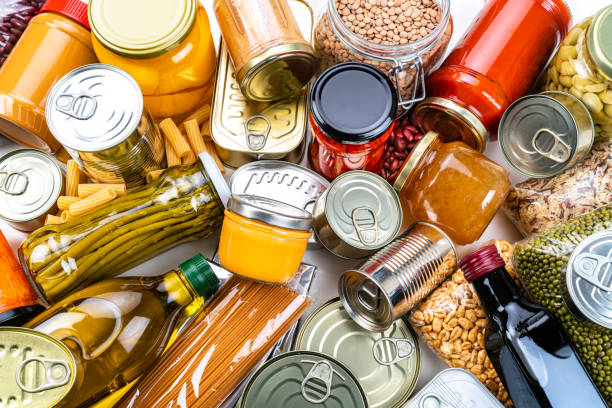 istock Non-perishable food background: canned goods, conserves, sauces and oils. Overhead view. 1282707014