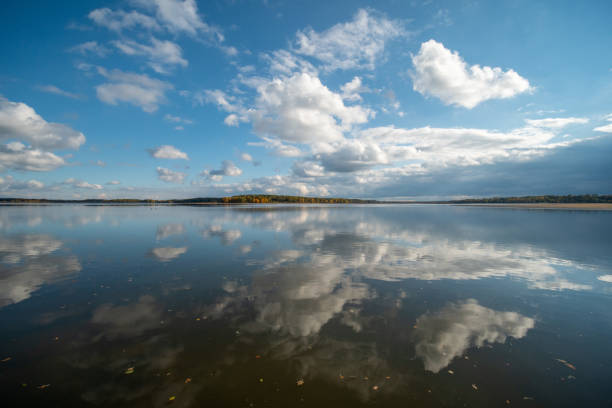 Karvinske more lake with colorful forest on the background near Karvina city in Czech republic during autumn