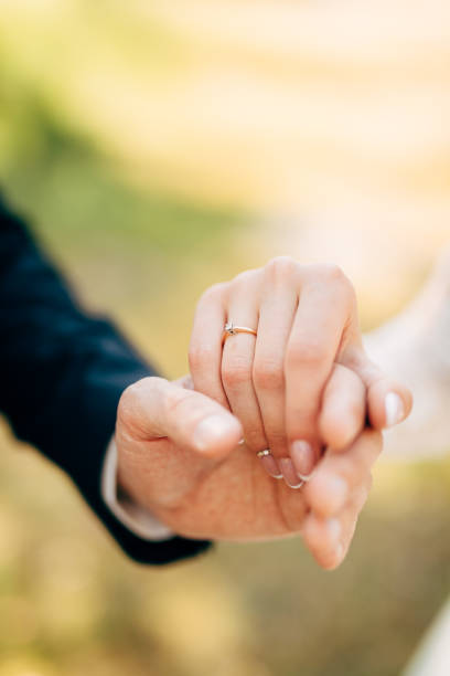 istock hands of groom and bride hold together 1282712838