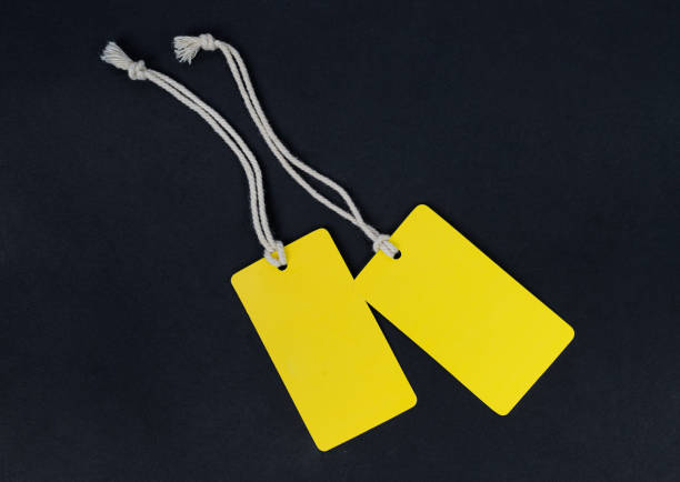 istock Mock up of two yellow paper labels on a black background. 1282714593
