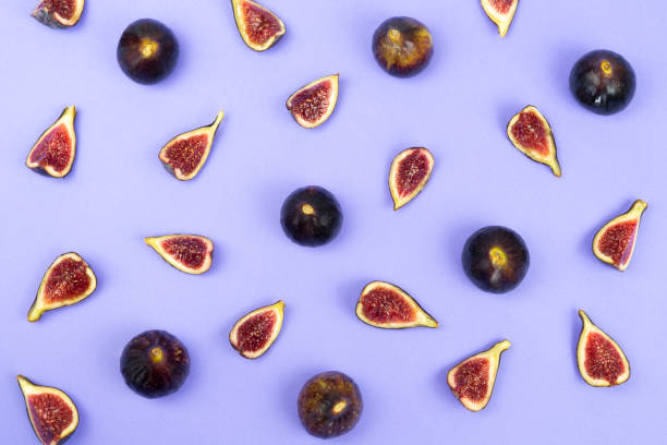 istock Entire and chopped figs on a blue background. Flat lay. 1282715372