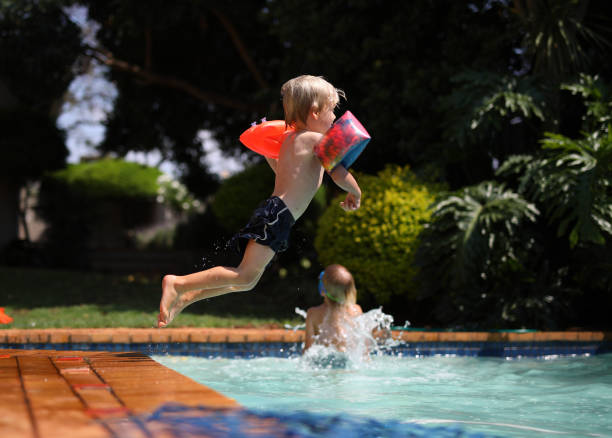 istock Young boys playing in the swimming pool 1282715617