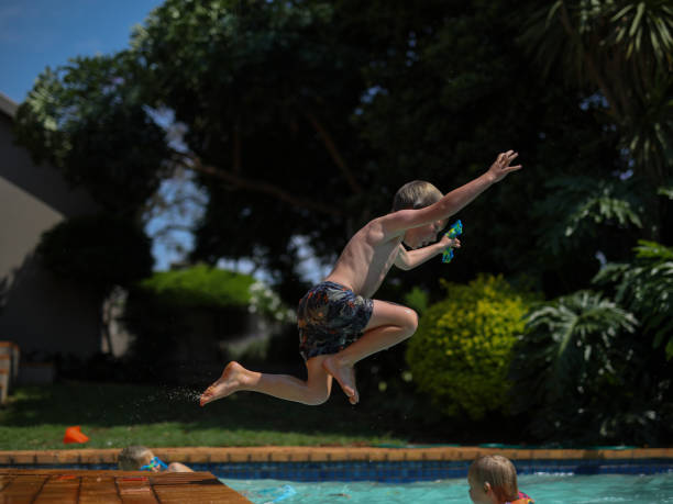 istock Young boys playing in the swimming pool 1282715713