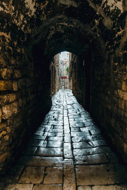 istock Dark narrow street in old town. Split, Croatia 1282716946
