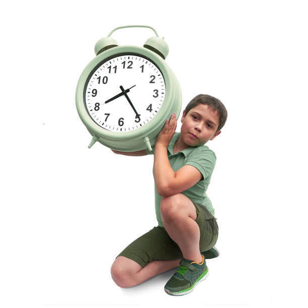 istock Schools start too early. Little boy with large alarm clock 1282718064