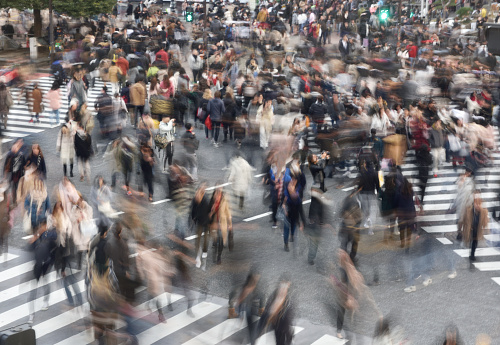 Blur motion of walking people in Shibuya crossing, Tokyo, Japan. Shibuya crossing is one of the most iconic place in Tokyo. Lots of people cross the road every day.