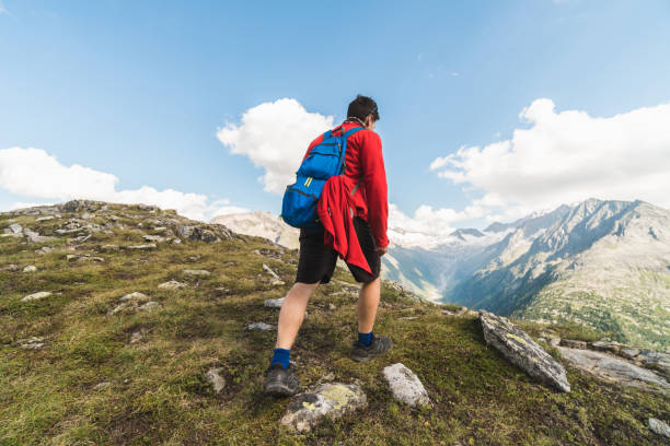 istock Young backpacker hiking a trail in the Alps mountains in Austria 1282719150