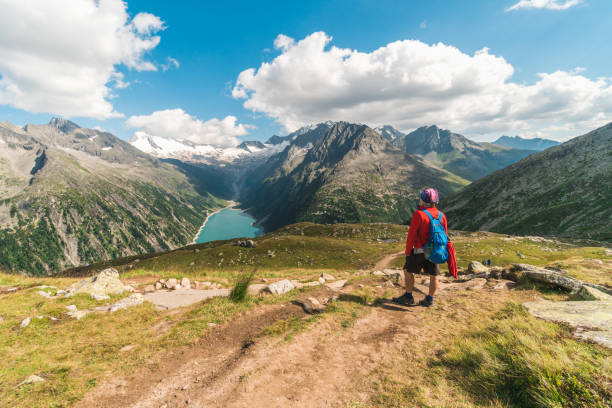 istock Young backpacker hiking a trail in the Alps mountains in Austria 1282719321
