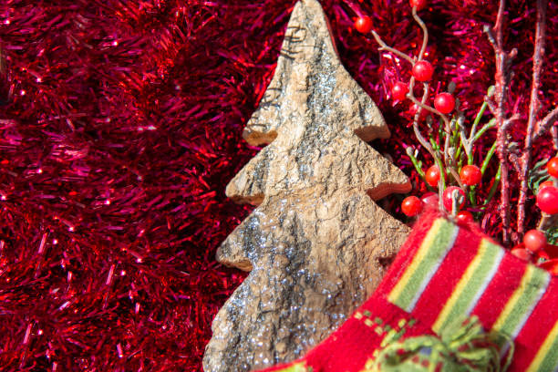 istock Festive Christmas background with a tree bark Christmas tree on a festive red tinsel background 1282719347