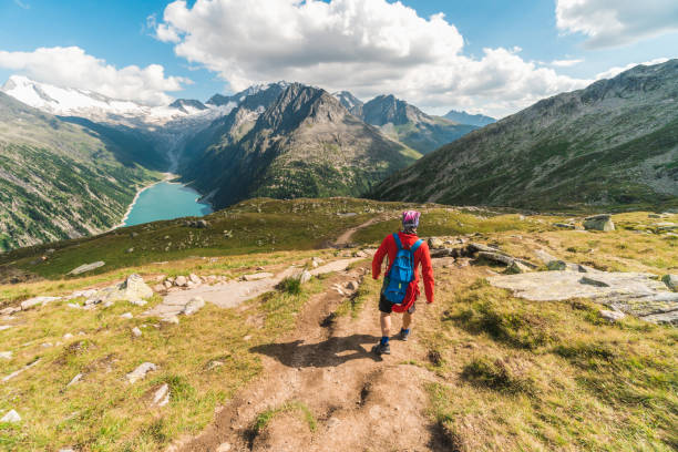 istock Young backpacker hiking a trail in the Alps mountains in Austria 1282719370
