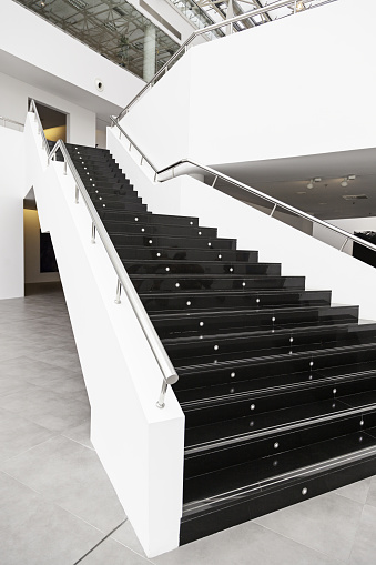 Black marble stairs, detail of the interior of a modernist building, modern architecture