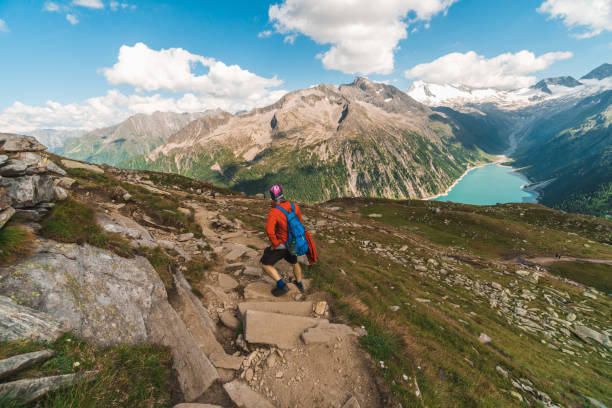 istock Young backpacker hiking a trail in the Alps mountains in Austria 1282719417