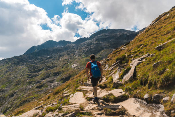 istock Young backpacker hiking a trail in the Alps mountains in Austria 1282719496