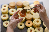 Woman making traditional german spitzbuben Christmas cookies linzer biscuit cookies filled with marmalade