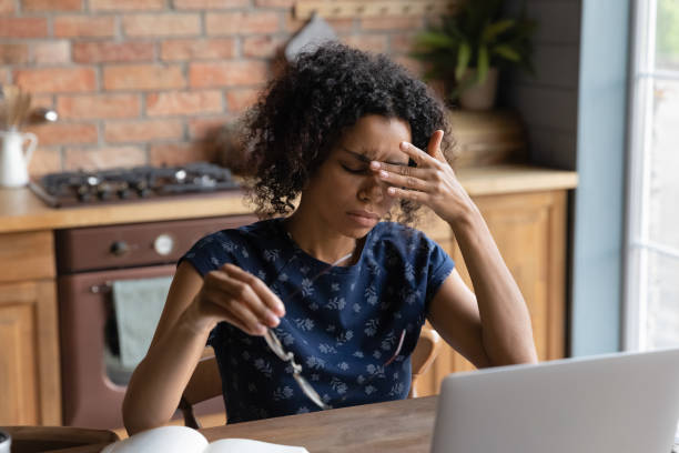 istock Tired biracial woman suffer from migraine working on laptop 1282721987