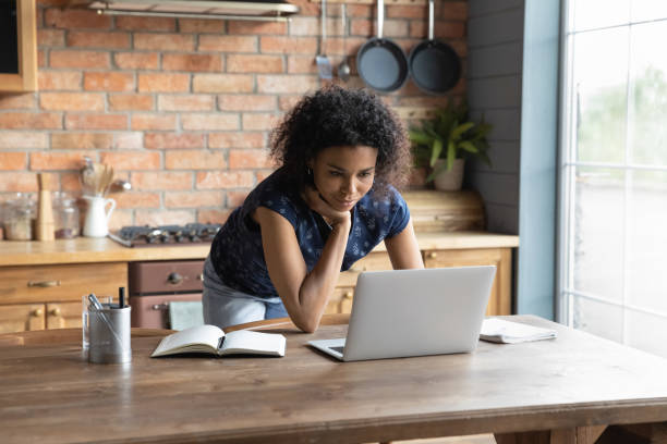 istock African American woman work on laptop at home kitchen 1282721992