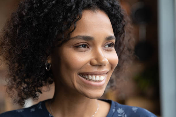 istock Smiling biracial woman look in distance dreaming visualizing 1282722006